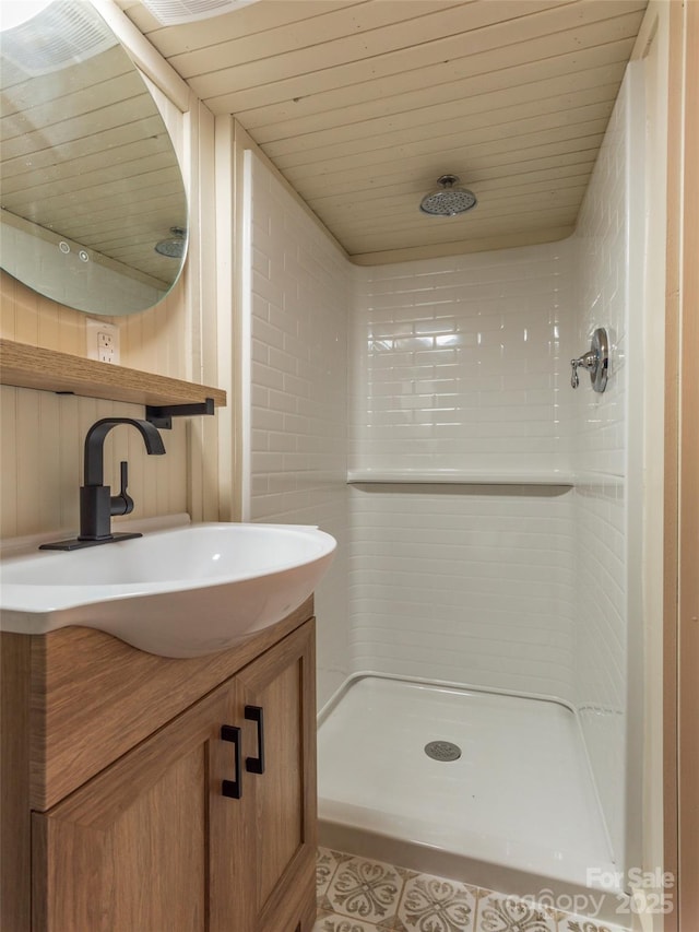 bathroom with vanity, wooden ceiling, and walk in shower