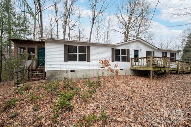 rear view of property featuring a deck