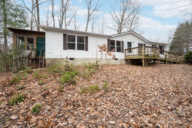 rear view of property featuring a deck