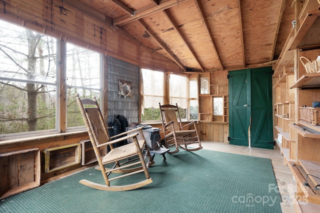 sunroom / solarium featuring lofted ceiling with beams and wooden ceiling