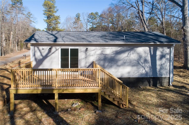 back of house featuring a wooden deck