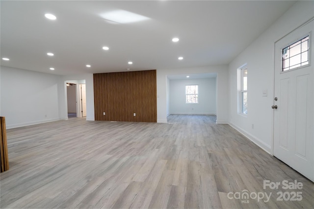 unfurnished living room with light hardwood / wood-style flooring