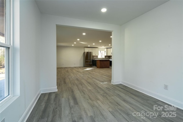 unfurnished living room with hardwood / wood-style flooring and a wealth of natural light