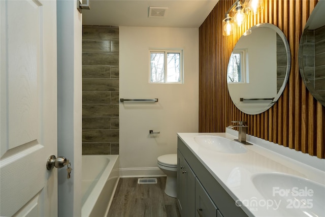 bathroom with wood-type flooring, toilet, and vanity