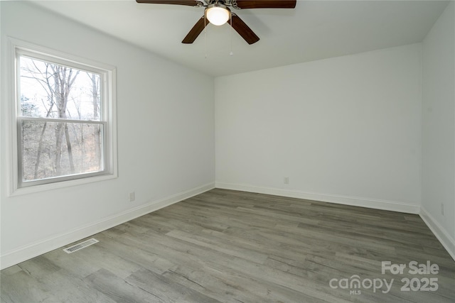 empty room featuring wood-type flooring and ceiling fan