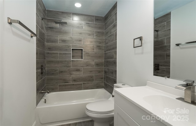 full bathroom with vanity, toilet, and tiled shower / bath