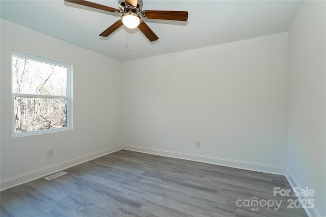 empty room with ceiling fan and hardwood / wood-style floors