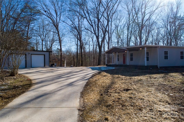 view of property exterior with a garage and an outdoor structure