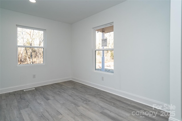 spare room with hardwood / wood-style floors