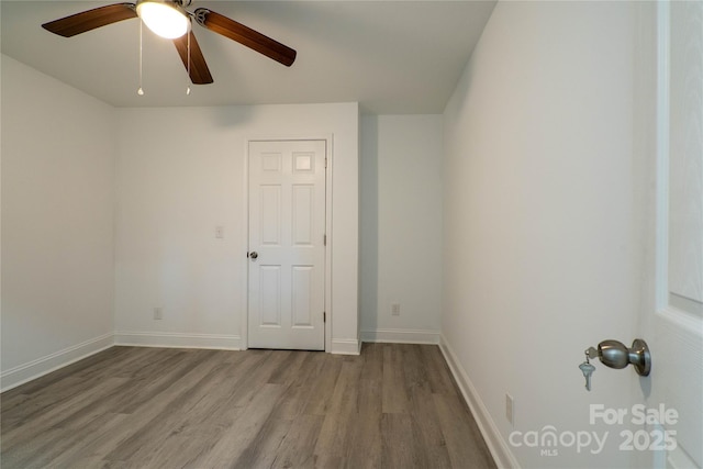 spare room featuring light hardwood / wood-style floors and ceiling fan