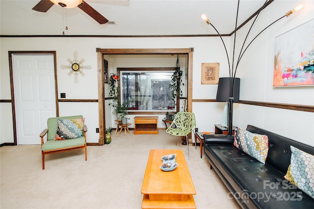 carpeted living room with ceiling fan