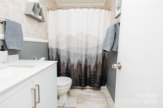 full bath with toilet, curtained shower, vanity, and tile patterned floors