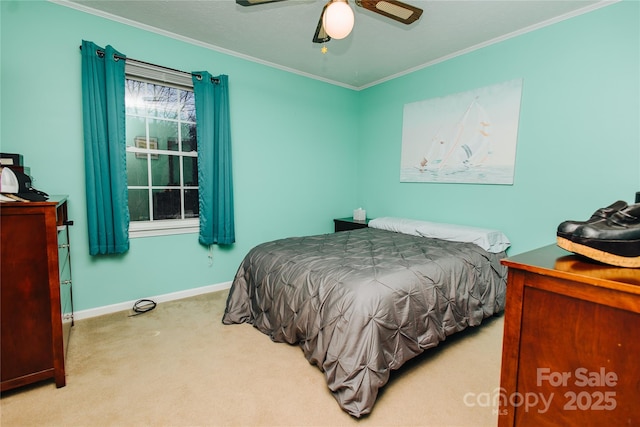 carpeted bedroom featuring ornamental molding, a ceiling fan, and baseboards