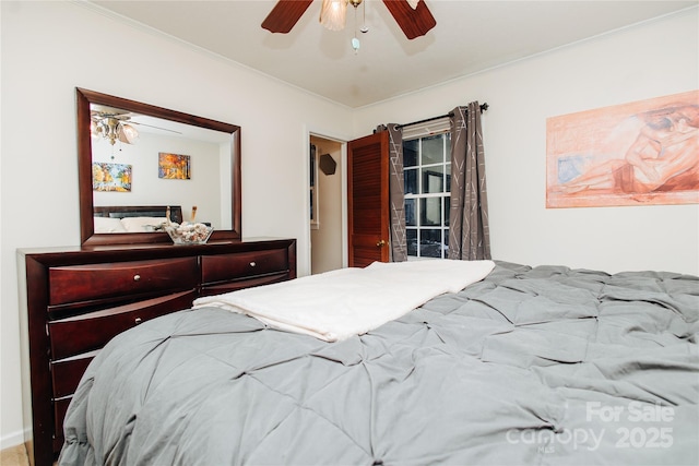 bedroom with ceiling fan and crown molding