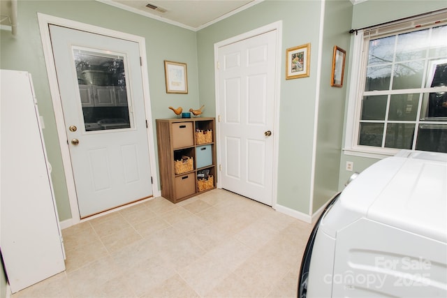 interior space with freestanding refrigerator, visible vents, crown molding, and baseboards