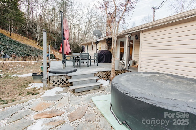 view of patio with a deck, outdoor dining area, and a grill