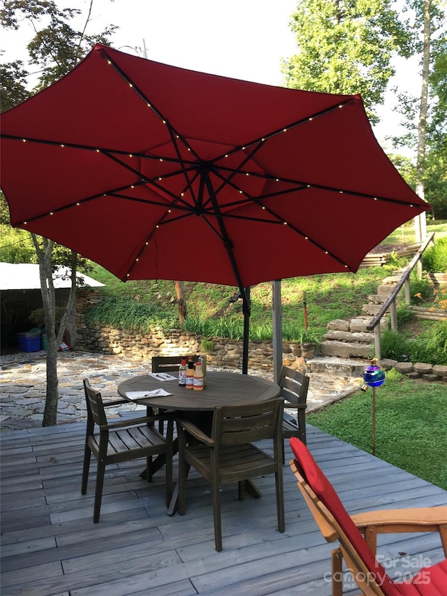 wooden terrace with outdoor dining space