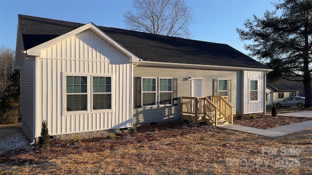 view of front of home with crawl space, a shingled roof, and board and batten siding