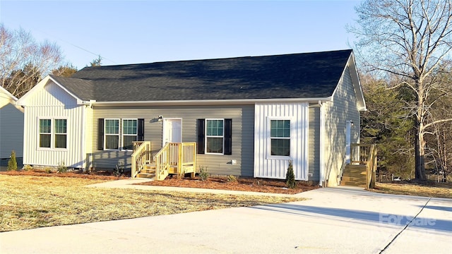 view of front of property featuring a shingled roof and board and batten siding