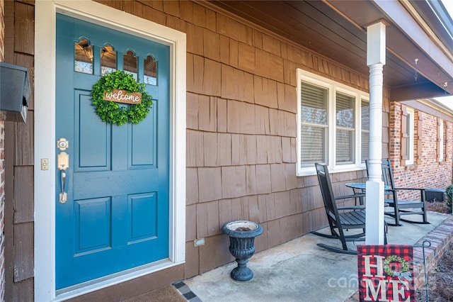 view of exterior entry with covered porch