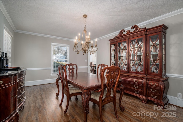 dining space featuring an inviting chandelier, a healthy amount of sunlight, dark hardwood / wood-style floors, and ornamental molding