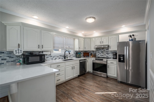 kitchen with sink, backsplash, white cabinetry, and stainless steel appliances