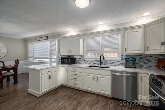 kitchen with sink, white cabinetry, and appliances with stainless steel finishes