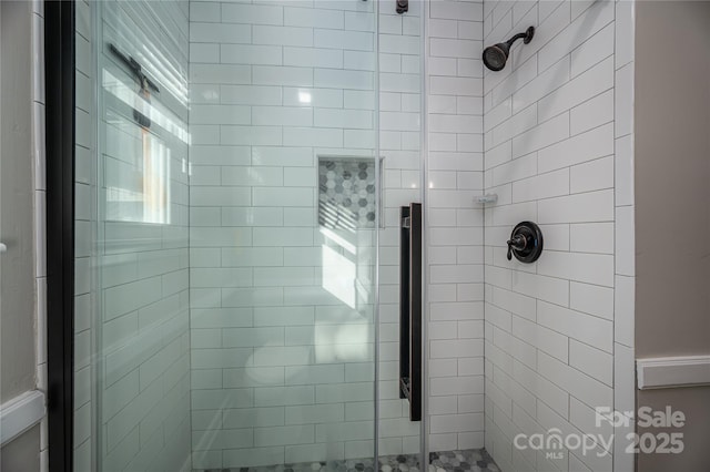 bathroom with a shower with shower door