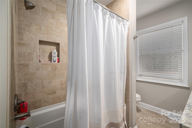 bathroom featuring tile patterned floors, toilet, and shower / tub combo