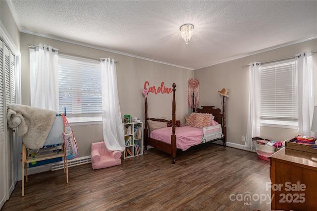 bedroom featuring ornamental molding, dark hardwood / wood-style flooring, and a textured ceiling