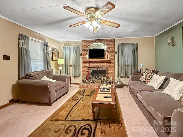 carpeted living area with a brick fireplace, crown molding, baseboards, and ceiling fan