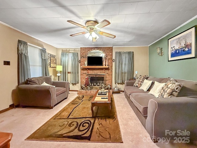 carpeted living area with ornamental molding, a brick fireplace, ceiling fan, and baseboards