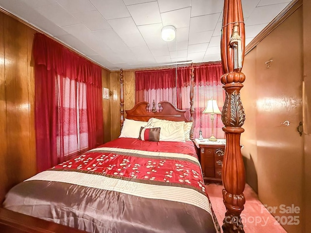 bedroom featuring wood walls