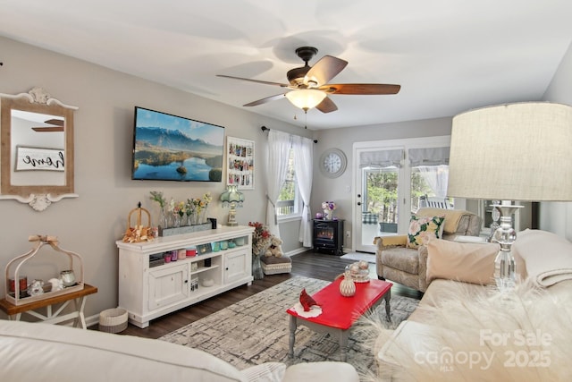 living room featuring ceiling fan and dark hardwood / wood-style flooring