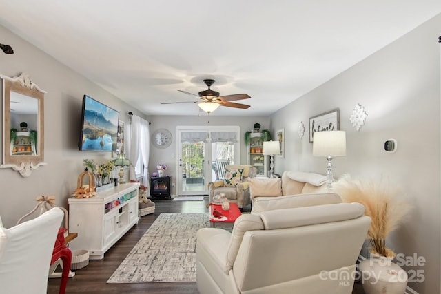 living room featuring dark hardwood / wood-style flooring and ceiling fan