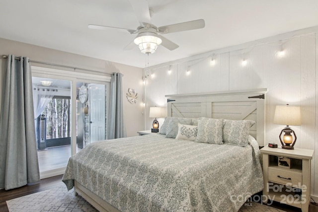 bedroom with dark hardwood / wood-style floors, access to exterior, and ceiling fan