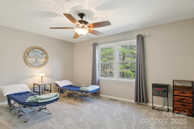 sitting room featuring light colored carpet and ceiling fan