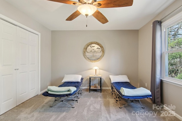 sitting room featuring ceiling fan and light colored carpet