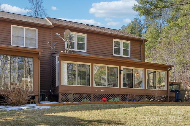 view of side of home featuring a yard and a sunroom