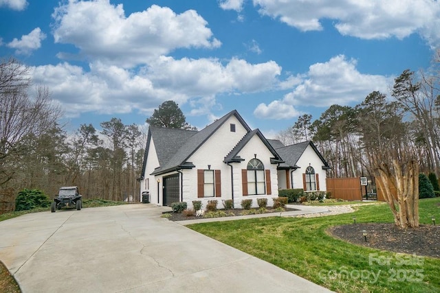 french country inspired facade with a garage and a front yard