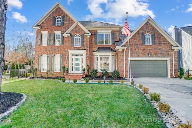 view of property with a garage and a front yard