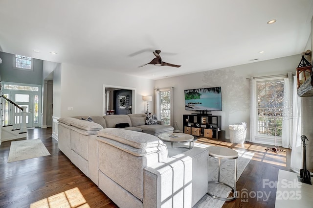 living room featuring dark wood-type flooring and ceiling fan