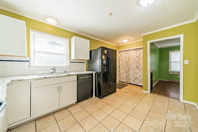 kitchen with sink, tasteful backsplash, black appliances, light tile patterned floors, and white cabinets