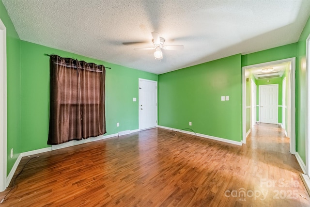 unfurnished room featuring ceiling fan, light hardwood / wood-style floors, and a textured ceiling