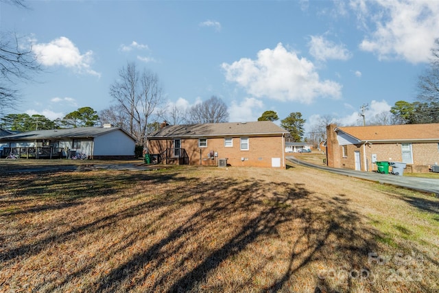 back of house with a lawn