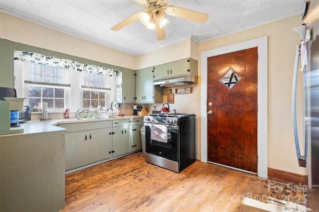 kitchen with sink, light wood-type flooring, ceiling fan, stainless steel range with gas cooktop, and crown molding