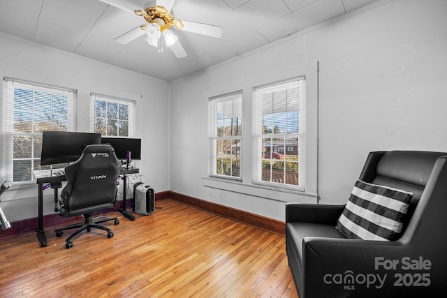 office space featuring wood-type flooring, ceiling fan, and ornamental molding