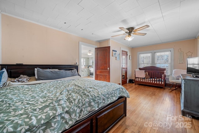 bedroom featuring ceiling fan, crown molding, and light wood-type flooring