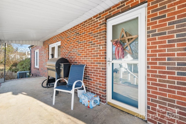 view of patio / terrace with central AC unit and a grill