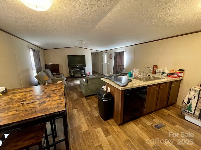 kitchen featuring ornamental molding, black dishwasher, sink, and light hardwood / wood-style flooring